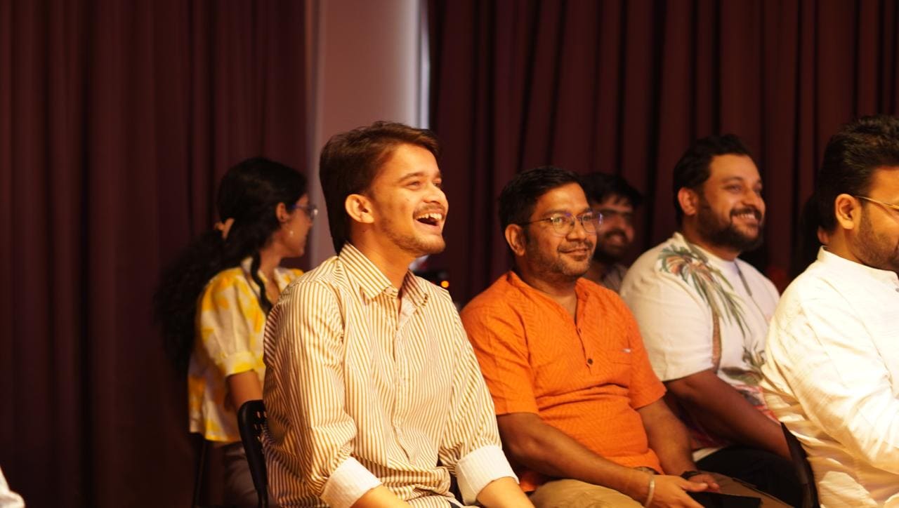 A man in the audience laughing during a performance