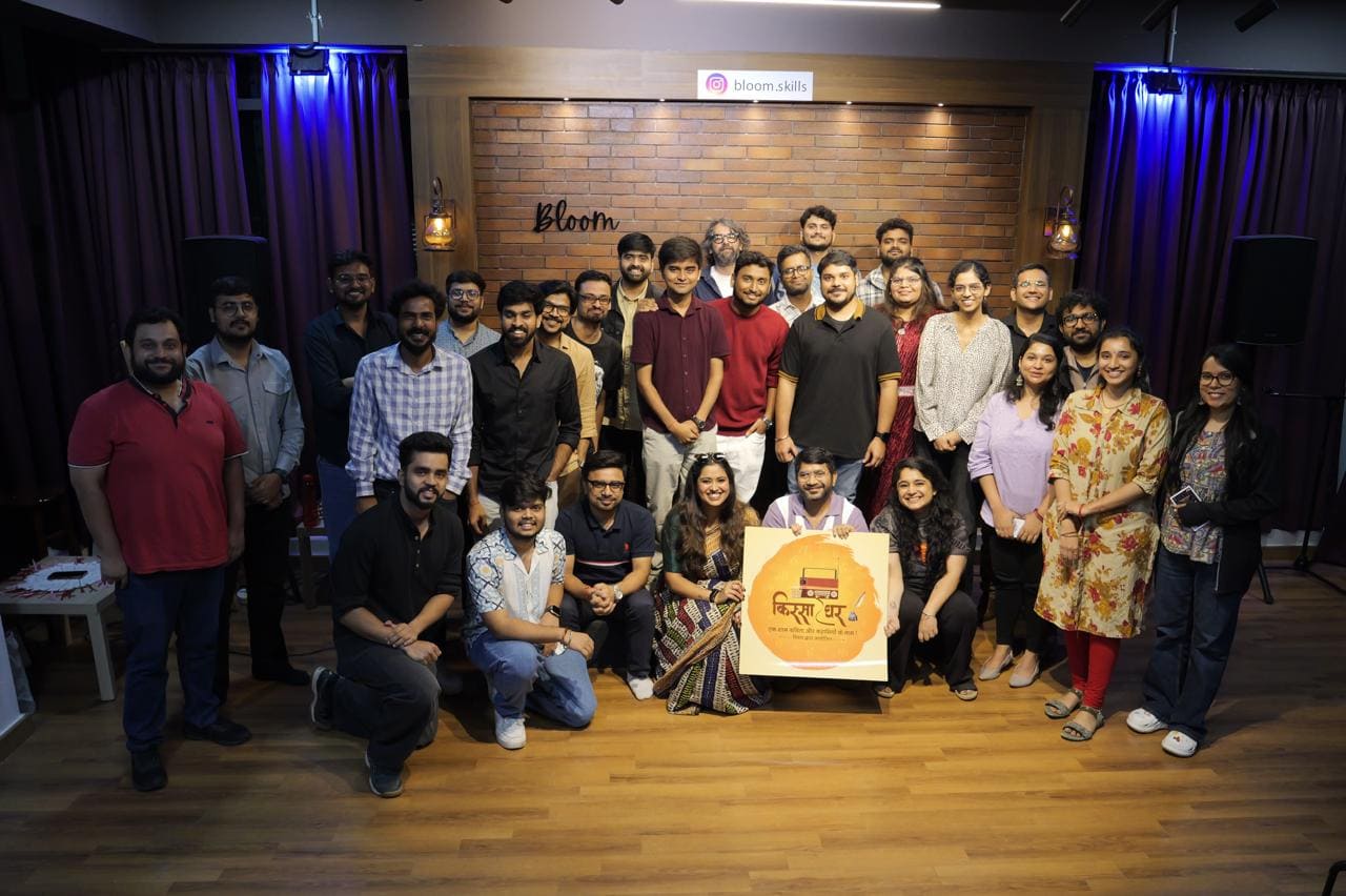 A large group of performers and organisers posing together on stage